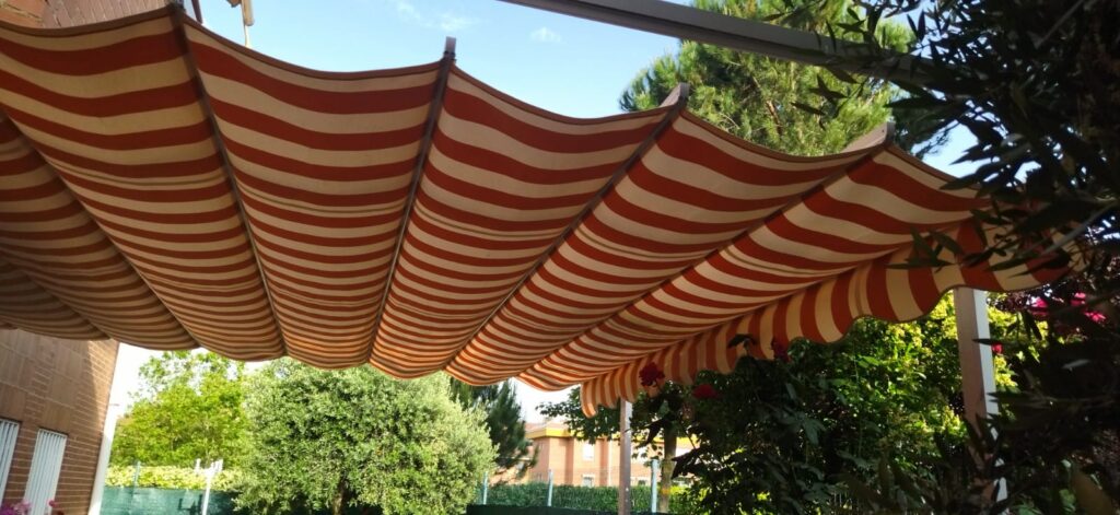 Pérgola renovada con sistema de palillería doble y lona corredera moderna.